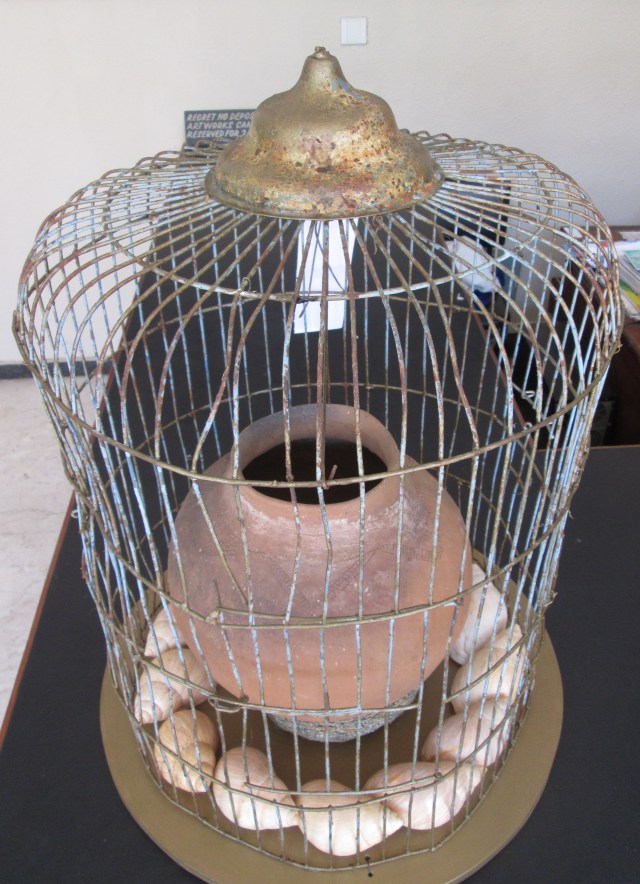 snail shells and fired pot in a cage.jpg
